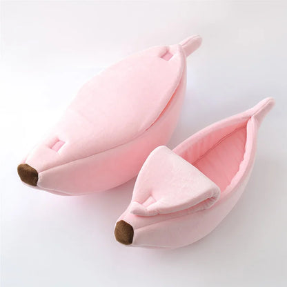 Pink banana-shaped slippers on a white background