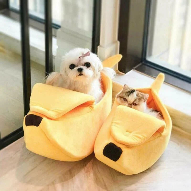 Two small dogs inside a yellow swan-shaped pet bed.