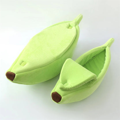 Green banana-shaped slippers on a white background